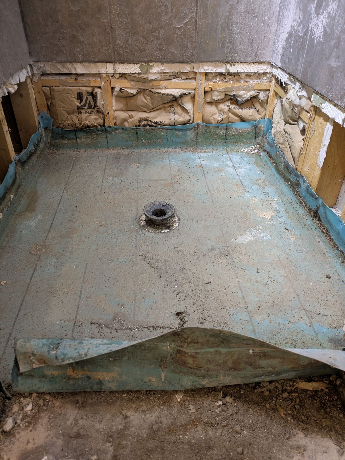 Exposing a failed shower pan liner in a Normaltown bathroom